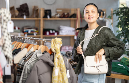 Adult woman choosing handbag in clothing storeの写真素材
