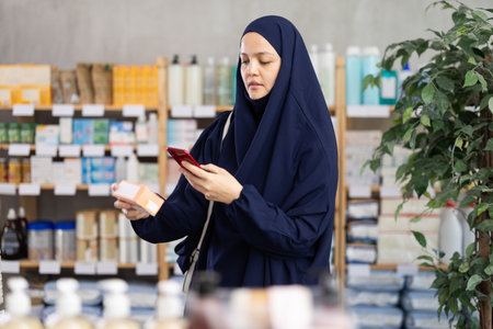 Muslim woman scans qr packages with pillsの写真素材