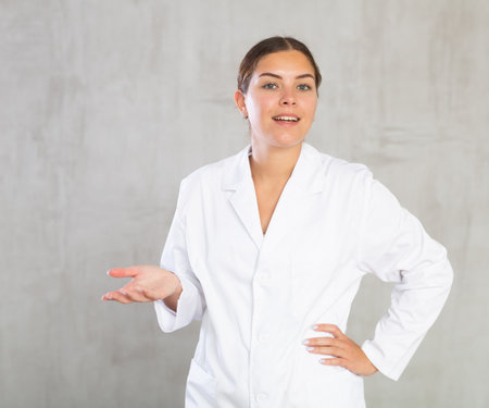 Young woman posing in medical uniform in studioの写真素材