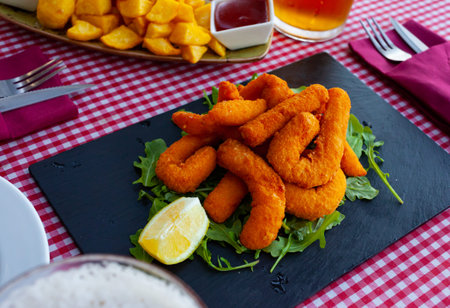 Fried sepia in a batter served with arugula and lemon