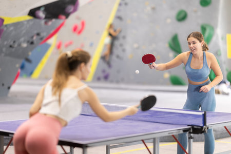 Two women play table tennis with passionの写真素材