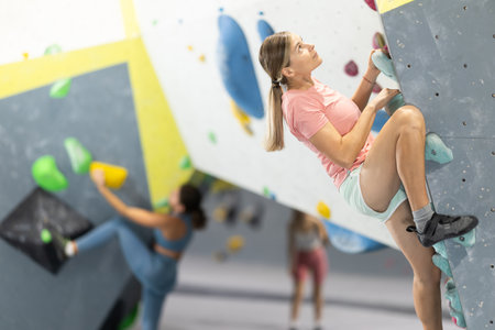 Woman training at bouldering gym without special climbing equipmentの写真素材