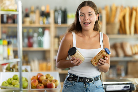 Young woman choosing beans in grocery storeの写真素材