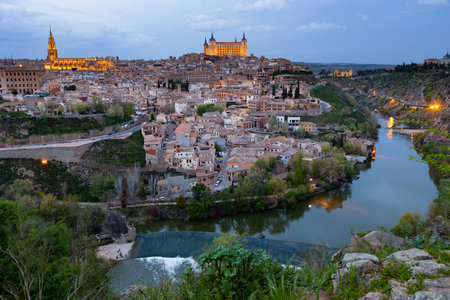 Toledo cityscape with lighted Cathedral and Alcazar in spring twilightの写真素材