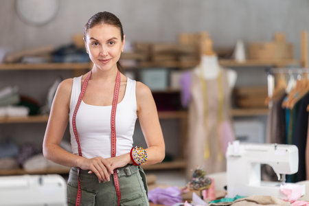 Young female dressmaker inviting clients to sewing workshopの写真素材