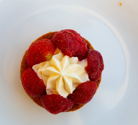 Strawberry dessert with cream on white plateの写真素材