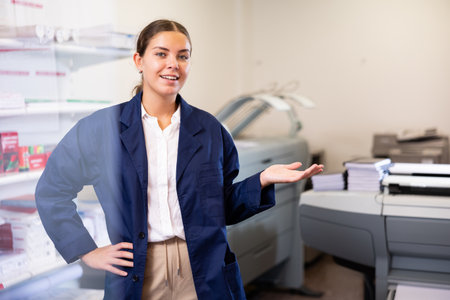 Print shop employee invites a customer to come insideの写真素材