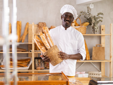 Portrait of positive man bakery workerの写真素材