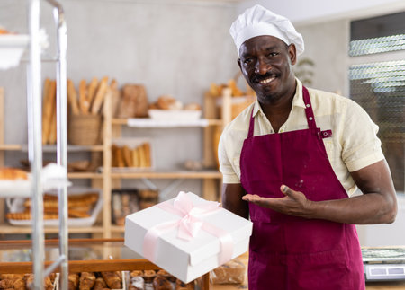 Portrait of male baker in apron with boxの写真素材
