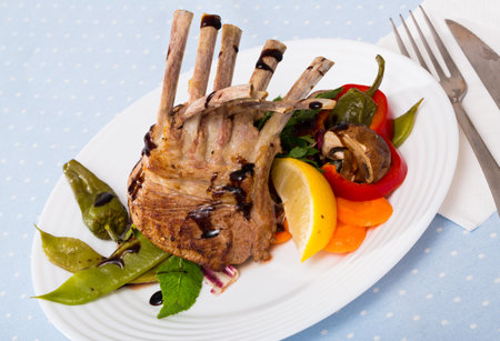 Baked rack of lamb with vegetablesの写真素材