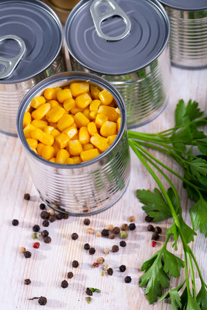 Canned corn on a wooden tableの写真素材