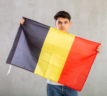 Portrait of young man of Belgium match waving national flagの写真素材