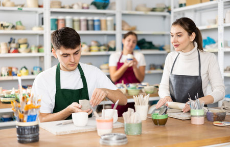 Young woman and young man making pottery