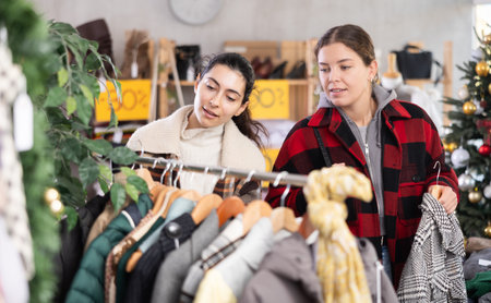 Two women came to a clothing store before Christmas for shoppingの写真素材