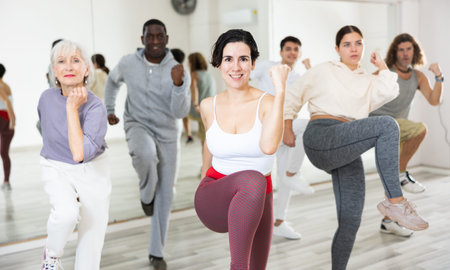 Happy Latina enjoying active dancing during group trainingの写真素材