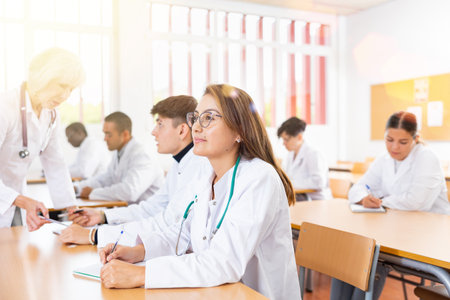 Young hispanic woman doctor listening lectures within refresher courseの写真素材