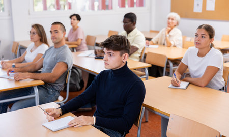 Focused guy attending foreign languages courses for adultsの写真素材