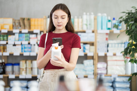 Woman scanning barcode of cream packageの写真素材