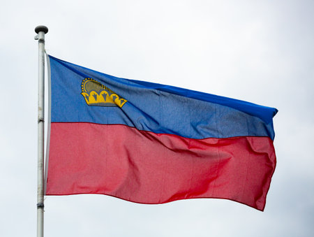 Flag of Liechtenstein waving on cloudy skyの写真素材