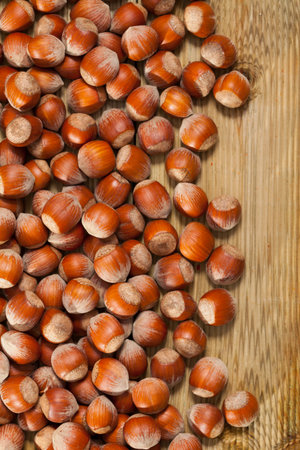 Unpeeled hazelnut on natural wooden background, nobodyの写真素材