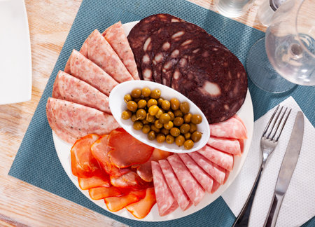 Antipasto platter with various meat and olivesの写真素材