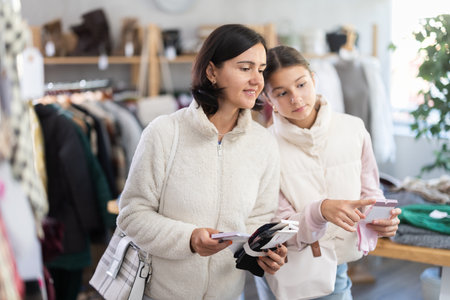 Adult woman and teenage girl choose socksの写真素材