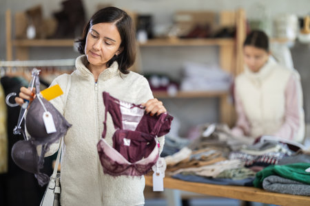 Adult woman chooses underwear in clothing storeの写真素材