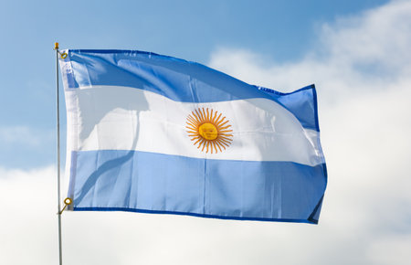 Flag of state of Argentina flutters against skyの写真素材