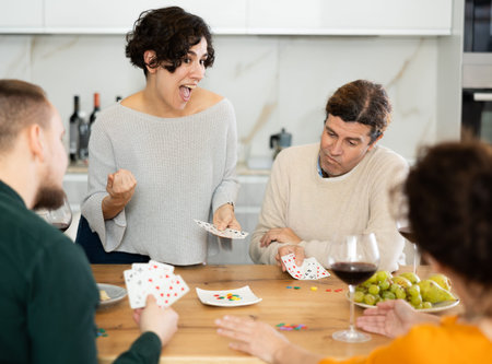 Two married couples playing card game poker