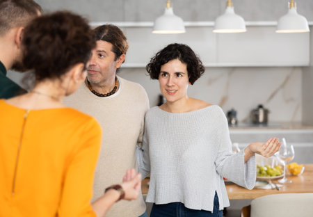 Husband and wife stand side by side and say goodbye to guests