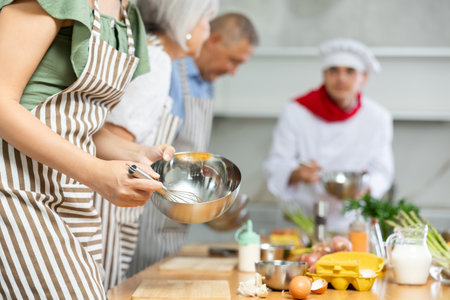 Cooking class, food and people concept - happy group of friends and male chef cook cooking in kitchenの写真素材