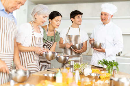 Experienced male chef giving group culinary classesの写真素材