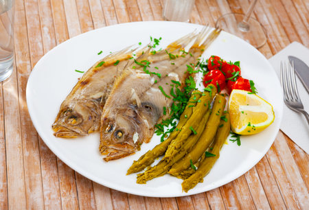 Oven baked rooster fish with marinated asparagus