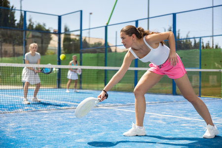 Woman standing on court and playing paddle tennisの写真素材