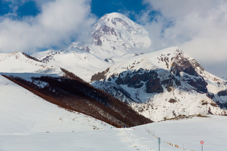 Rocky landscape of Caucasus mountains with snow covered Kazbekの写真素材
