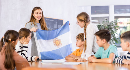 Teacher showing Argentina flag to group of schoolchildrenの写真素材
