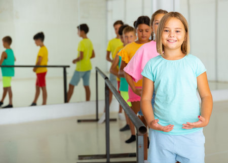 Group of smiling children practicing at ballet barreの写真素材