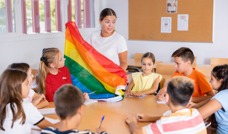 Female teacher talking about LGBT movements with preteen schoolchildrenの写真素材