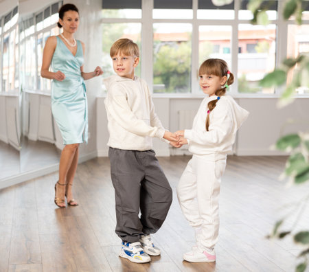 Boy and girl in sport wear train to dance contemporary vigorous rumba during classes.の写真素材