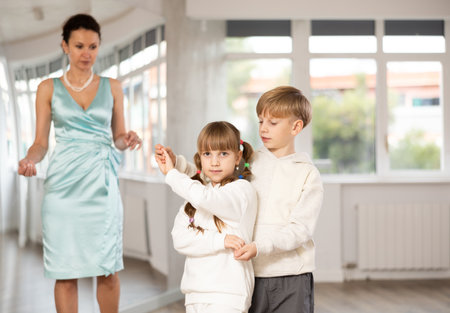 Boy with girl dressed in sport wear train to dance waltz during classes.の写真素材