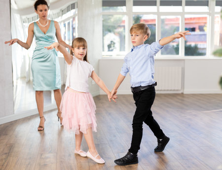 Boy and girl in pair train to dance contemporary vigorous waltz during classes.の写真素材
