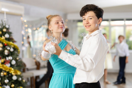 Boy and girl dancing waltz in studioの写真素材