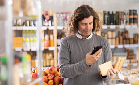 man scans a package of cheese on his phone