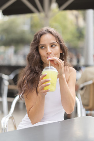 Young woman drinking in cafe