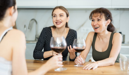 Three women have nice chat-in with wine and conversationの写真素材