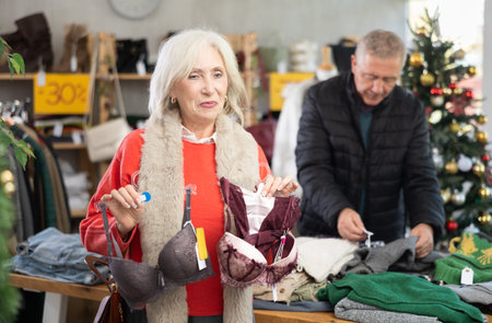 Mature woman chooses bra in fashionable clothing boutiqueの写真素材