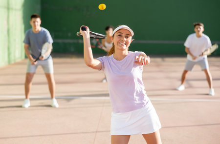 Woman player hitting ball with racketの写真素材