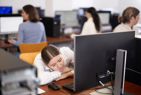 Young woman fell asleep at table in office