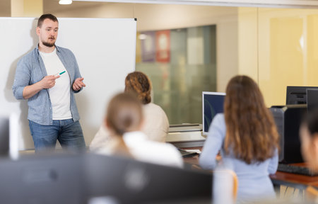 Young man giving presentation in officeの写真素材