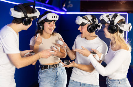 Group of friends chat animatedly after playing virtual realityの写真素材